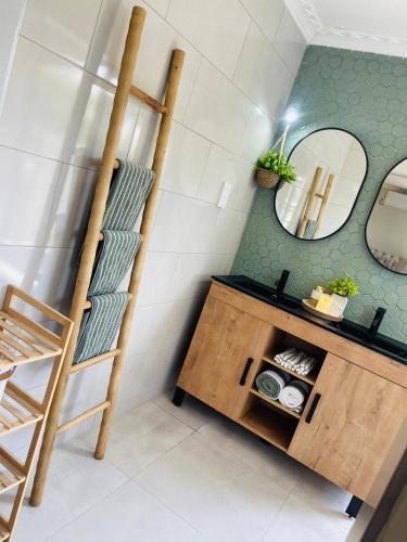 a bathroom with a wooden shelf and a mirror at Luna Holiday Home in Maun