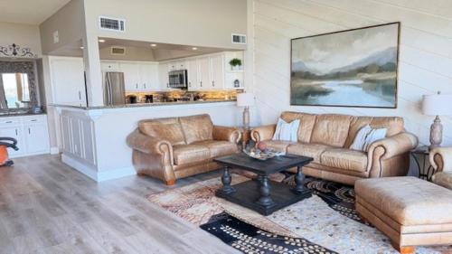 a living room with two couches and a table at Lake Vibes with Champagne Views in Montgomery