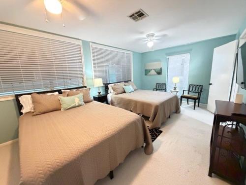 a bedroom with two beds in a room with blue walls at Lake Vibes with Champagne Views in Montgomery