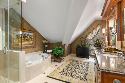a bathroom with a tub and a sink and a shower at Faraway Jackson Hole in Teton Village