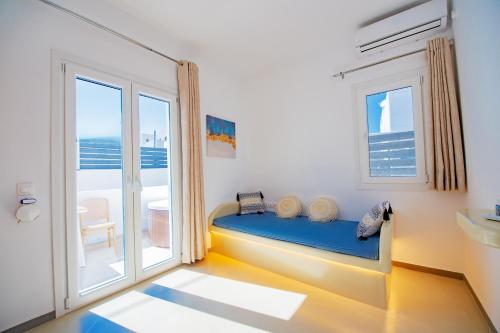 a bedroom with a bed and a large window at Santo Evdokia in Vóthon