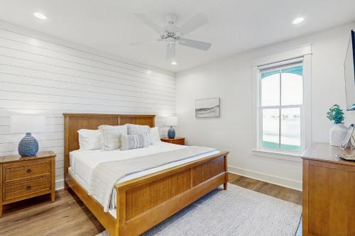 a bedroom with a large bed and a window at The Fairway Farmhouse in Port Aransas