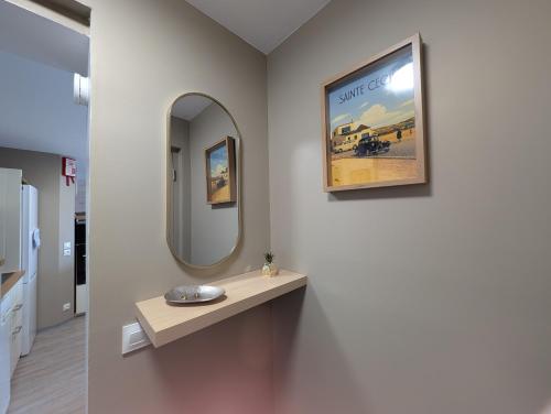 a bathroom with a mirror and a sink at La vague in Camiers