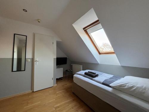 a bedroom with a bed and a skylight at Zimmer-Bad-TV-Kühlschrank-16 in Meine