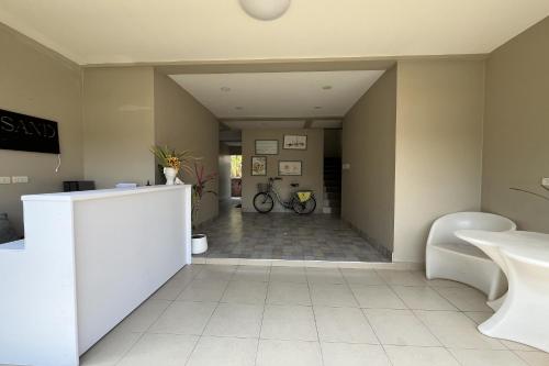 a room with a hallway with a bike in it at Surf & Sand Resort in Hua Hin