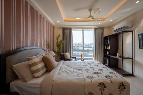 a bedroom with a large bed and a large window at The Hi-Rise in Gurgaon