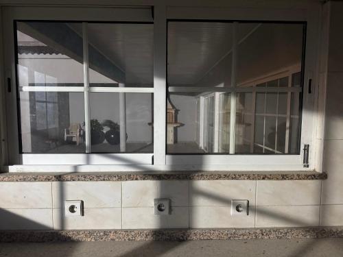 a building with large windows on the side of it at Casa da Lua, com espaço gourmet no Lubango, Huila in Lubango