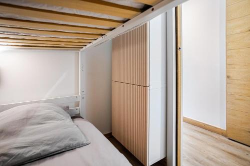 a small bedroom with a bed and a closet at L'Alpage - Serre Chevalier in Saint-Chaffrey