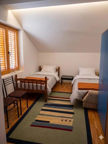 a bedroom with two beds and a rug at Entire Villa or Rooms! Spacious Villa in Nizepole Hiking, Peace, Private Events in Bitola