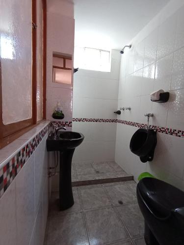 a bathroom with a sink and a toilet at Casa Amadeus in Estanciasuyo