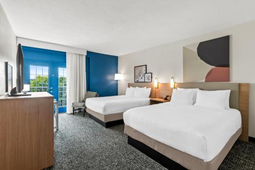 a hotel room with two beds and a tv at Spark by Hilton Chattanooga Downtown in Chattanooga