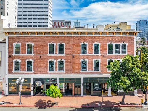 a large brick building on a city street at The Beau Hotel Downtown San Diego Gaslamp Quarter in San Diego