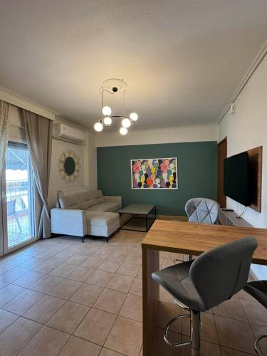 a living room with a couch and a table at Central appartment 2 with parking in Larisa