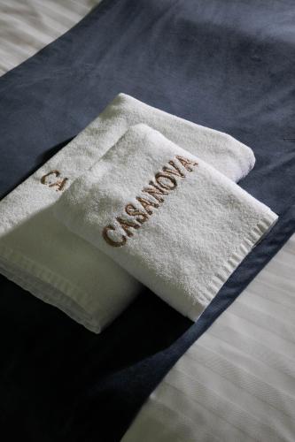 a towel with the word comfort written on it on a bed at Casanova Inn - Boutique Hotel in Dilijan
