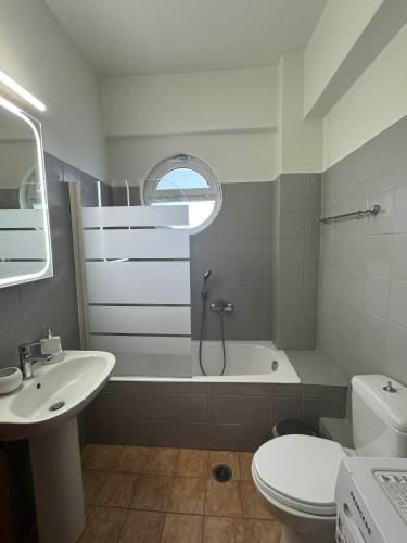 a bathroom with a shower and a sink and a toilet at Central appartment 2 with parking in Larisa