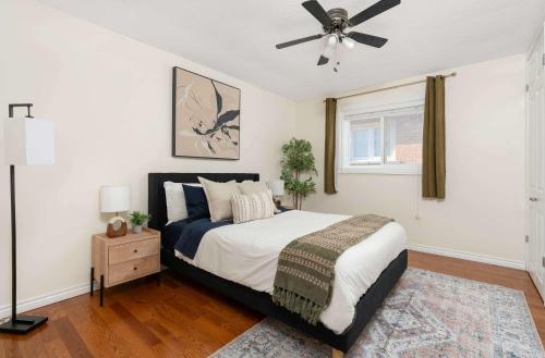 a bedroom with a bed and a ceiling fan at Huge 4 Bedroom House Near Square One - Sleeps 8 in Mississauga