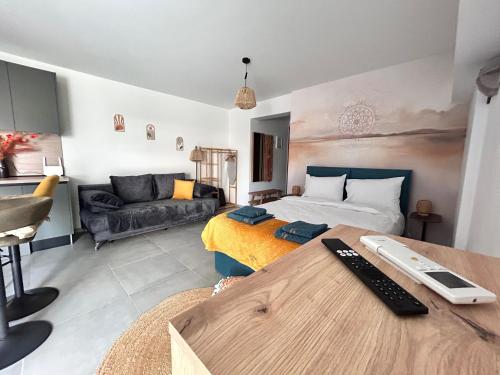 a living room with a bed and a couch at Boho Studio Enjoy in Neoi Epivates
