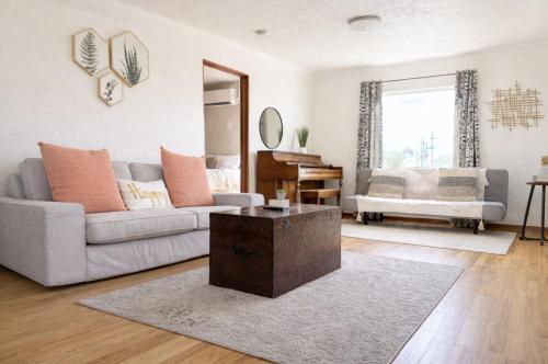 a living room with a couch and a table at Charming 2BD downtown home by bike trail, river and coffee! in Redding
