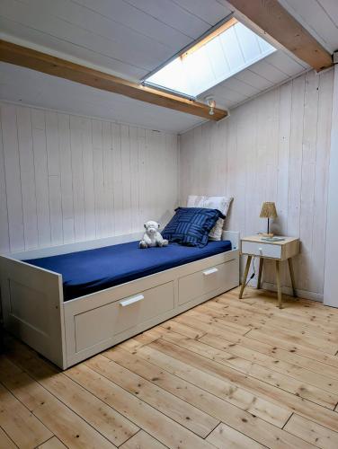 a bedroom with a bed with a teddy bear on it at Le Chant des Arbres in Grane
