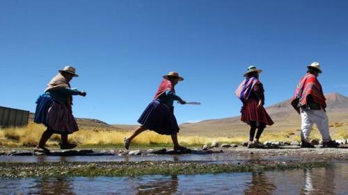 a group of people walking across a body of water at Valeria Victoria in Los Limos