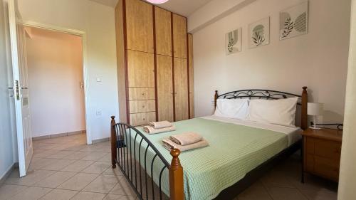 a bedroom with a bed with two towels on it at KAZARMA Luxury House in Pilikáta