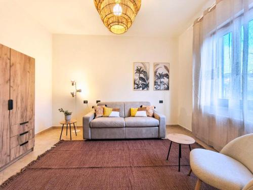 a living room with a couch and a large window at I sogni di Elias in Tuoro sul Trasimeno