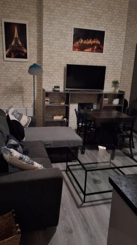a living room with a couch and a piano at Zak Air B&B Stay 9 people's in Birmingham