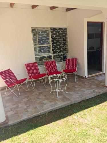 a group of chairs and a table on a patio at Casa con Jardín in Cochabamba