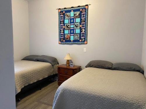 a bedroom with two beds and a stained glass window at Rudolph's Reindeer Den in Ketchikan