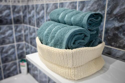 a pile of towels sitting on a shelf in a bathroom at City Square, center in Subotica
