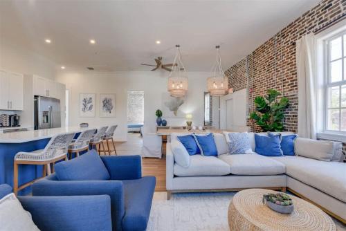 a living room with a white couch and blue chairs at Harbor House Penthouse- B in Key West