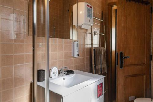 a small bathroom with a sink and a mirror at Di&Ana III - Alojamento Redondo in Redondo