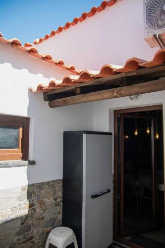a black and white refrigerator in a house at Di&Ana III - Alojamento Redondo in Redondo