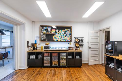 a coffee shop with a counter in a room at HI Coimbra - Pousada de Juventude in Coimbra