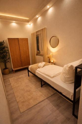 a bedroom with a bed and a mirror at CitySuite Borken Hessen in Borken