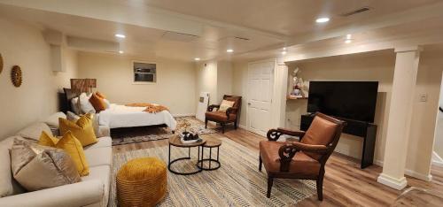 a large living room with a bed and a tv at Starlight Guesthouse in West Orange