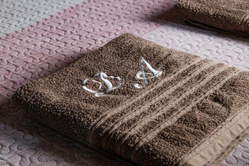 a blanket on a bed with two rings on it at Di&Ana - Alojamento Redondo in Redondo