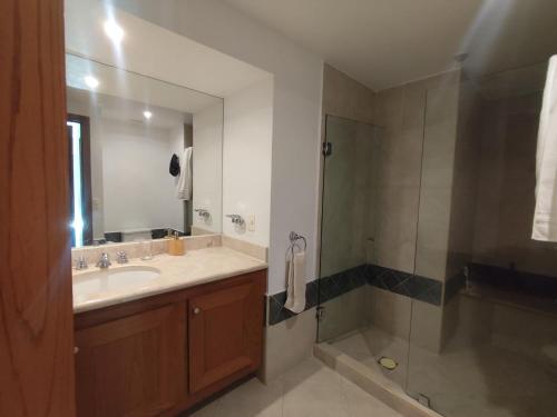 a bathroom with a sink and a shower at IXTAPA LUXURY - BVG 405 Norte in Ixtapa