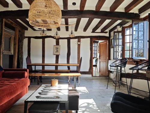 a living room with a couch and a table at Golf&Love in Normandy in Sainte-Opportune-du-Bosc