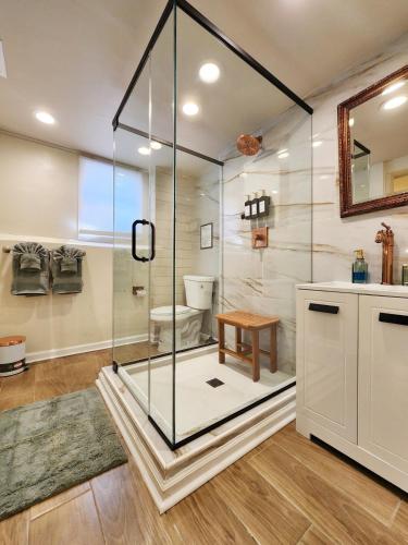 a glass shower in a bathroom with a toilet at Starlight Guesthouse in West Orange