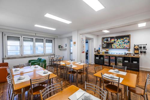 a restaurant with tables and chairs in a room at HI Coimbra - Pousada de Juventude in Coimbra