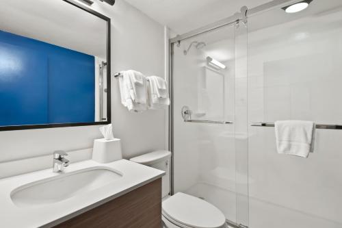 a bathroom with a toilet and a sink and a shower at Spark by Hilton Chattanooga Downtown in Chattanooga