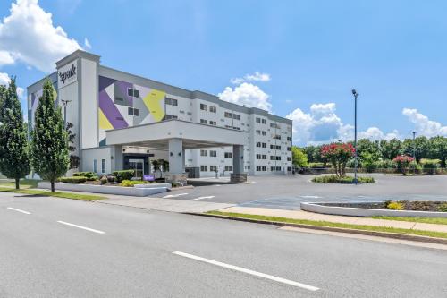 a large white building with a parking lot at Spark by Hilton Chattanooga Downtown in Chattanooga