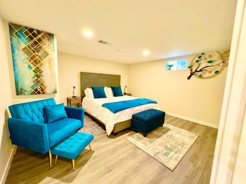 a bedroom with a bed and a blue chair at Private Residence Below Basement in Thornton