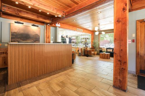 a lobby of a restaurant with a wooden wall at Bayshore Inn & Spa in Waterton Park