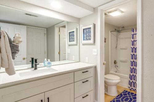 a white bathroom with a sink and a toilet at Relax Poolside! Lake-View Retreat in Osage Beach in Osage Beach