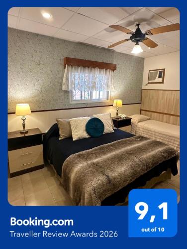 a hotel room with a bed and a window at Hotel Sans Souci in Belén de Escobar
