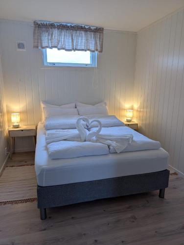 a bed with two hearts on it in a bedroom at Leilighet in Bjørkheim