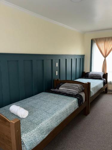 a bedroom with two beds and a window at Bercy in Valdivia