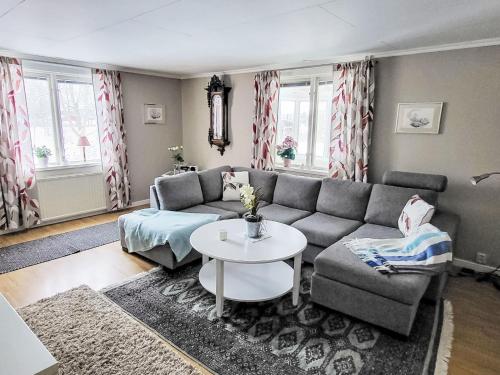 a living room with a couch and a table at Villa Äppelgården by Interhome in Örebro
